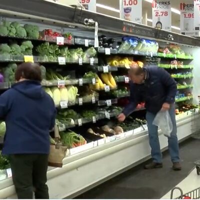 Elderly grocery shoppers selecting fresh fruits and vegetables in the produce section of HyVee, a grocery store in Sioux City, Iowa that participates in Double Up Food Bucks.